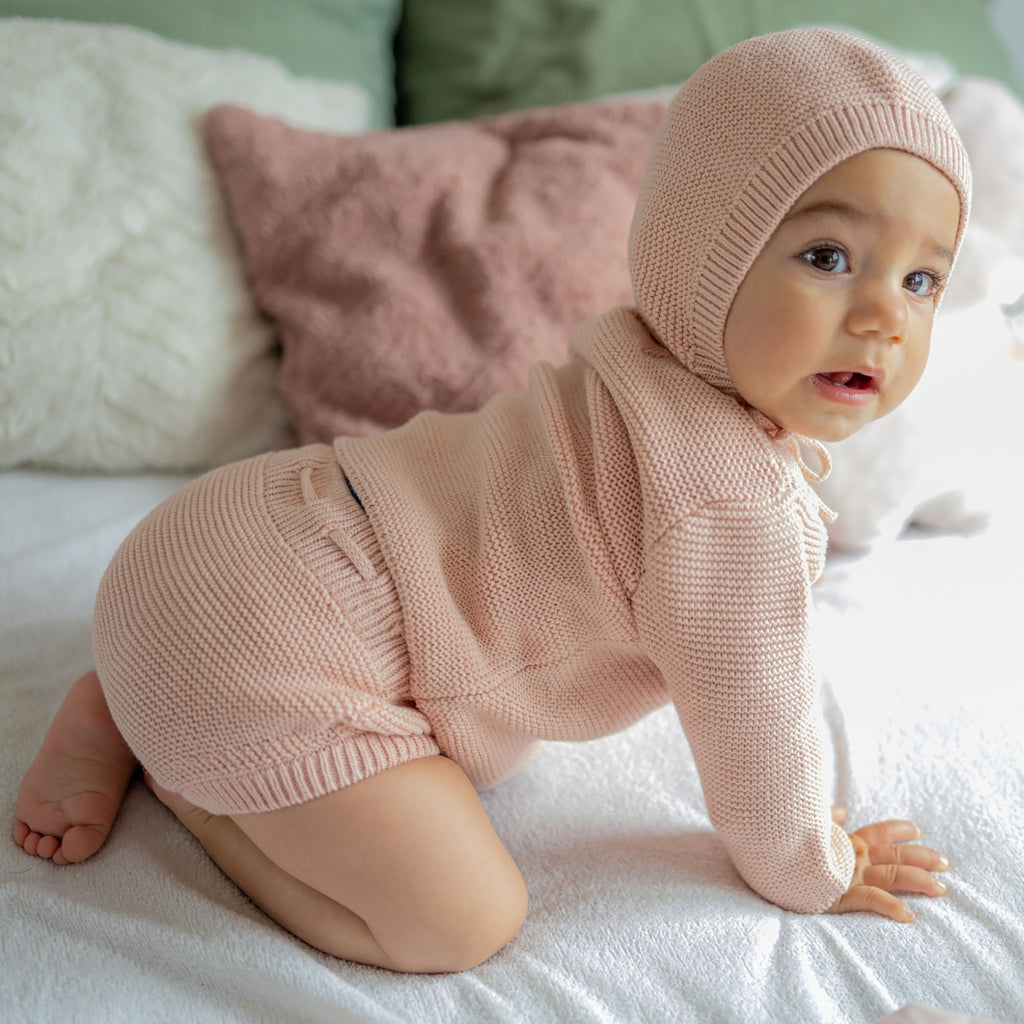 Knitted baby hat with garter stitch pattern, made from merino wool and organic cotton.