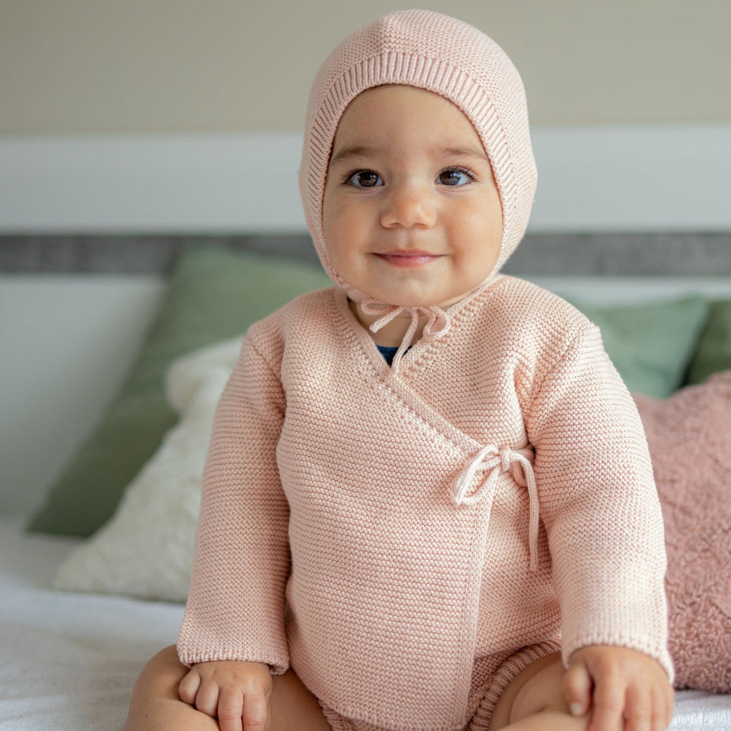 Knitted baby hat with garter stitch pattern, made from merino wool and organic cotton.